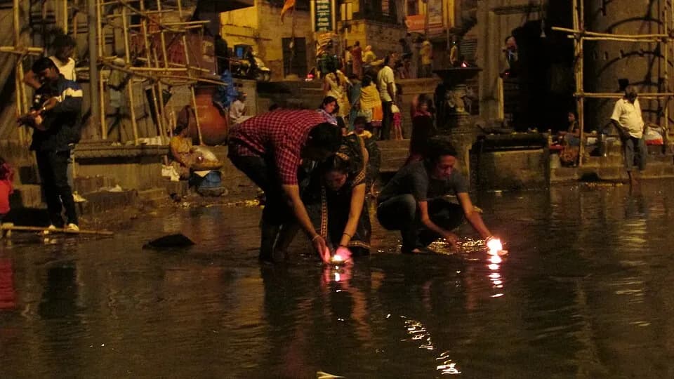 Devotees lighting lamps in the Godavari river at Nashik