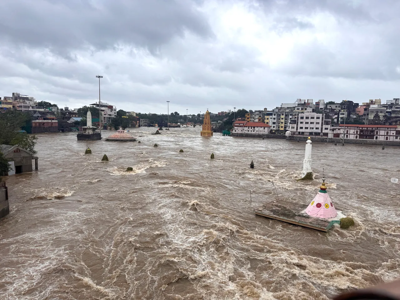 Flooded Godavari river at Ramkund, Panchavati, Nashik, seen from Ahilyabai Holkar Bridge